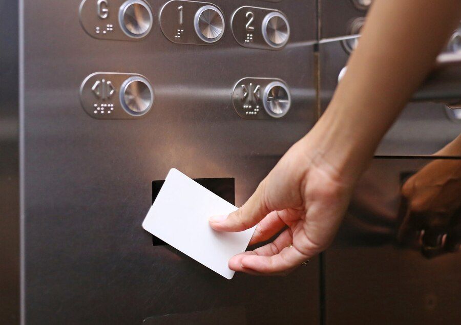 elevator-access-control-hand-holding-key-card-unlock-elevator_38678-266.jpg